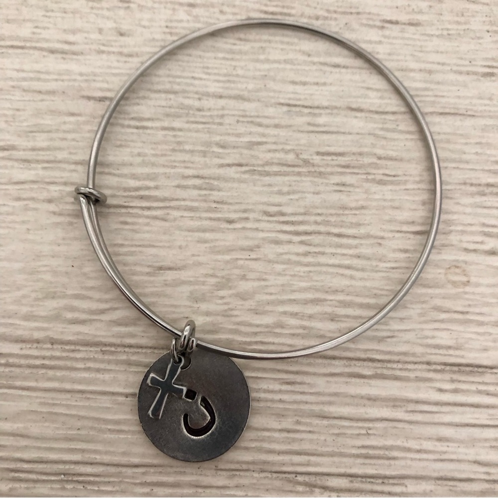 Bracelet with Nazarene symbol charm and cross charm.